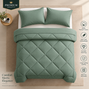 A green quilted comforter set with two matching pillowcases on a bed, shown in a styled bedroom scene with a beige wall and floor. The image includes text overlays highlighting product features such as '100% Premium Cotton', 'Ultra Soft & Breathable', 'Durable Stitching', 'Long Lasting Quality', and 'Machine Washable'.